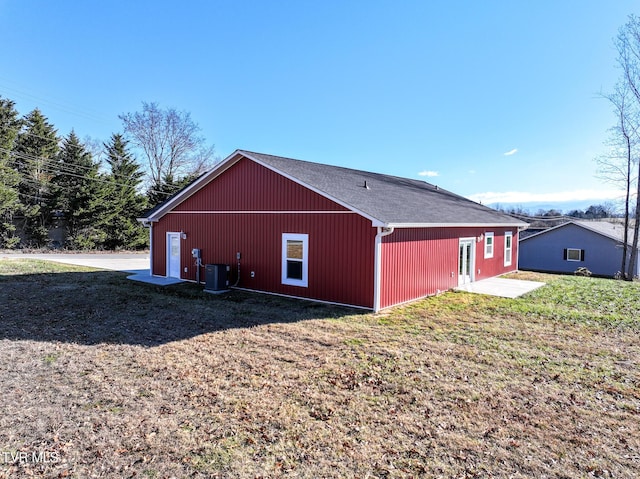 view of outbuilding featuring a yard and central air condition unit