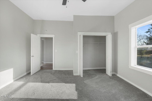 unfurnished bedroom featuring ceiling fan, a closet, carpet floors, and multiple windows