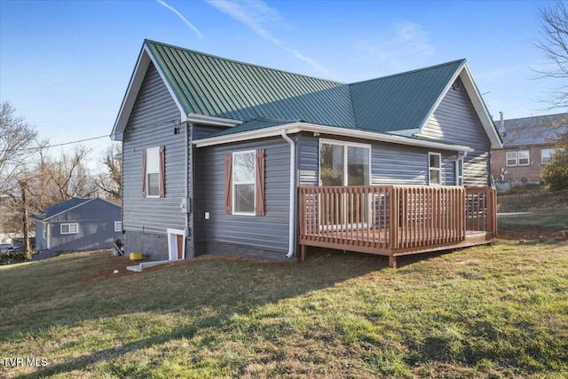 back of house featuring a yard and a wooden deck