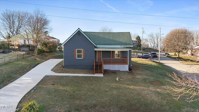 exterior space featuring covered porch and a yard