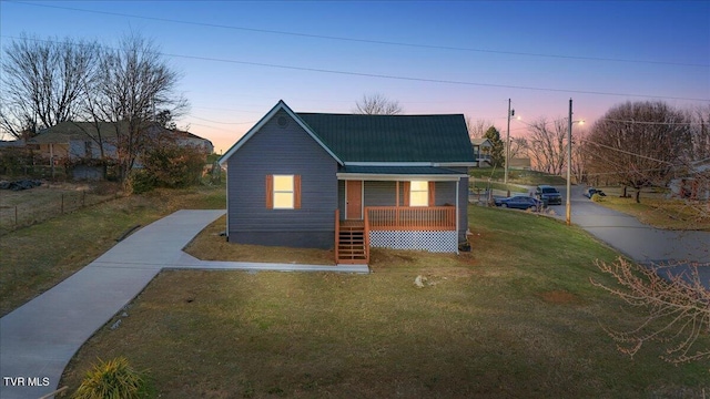 view of front of home with a yard and covered porch