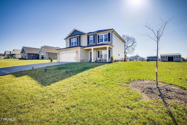 view of front property with a porch, a front yard, and a garage