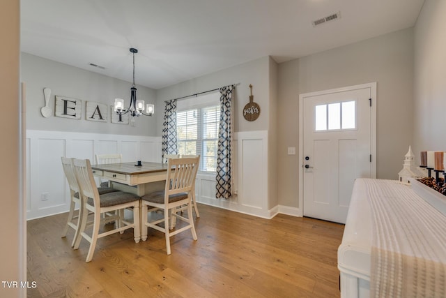 dining room with a notable chandelier and light hardwood / wood-style flooring