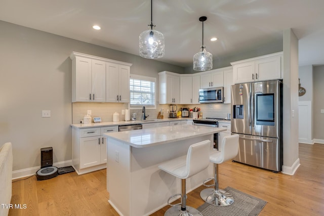 kitchen with white cabinets, a center island, and stainless steel appliances