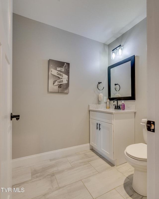 bathroom featuring tile patterned floors, vanity, and toilet