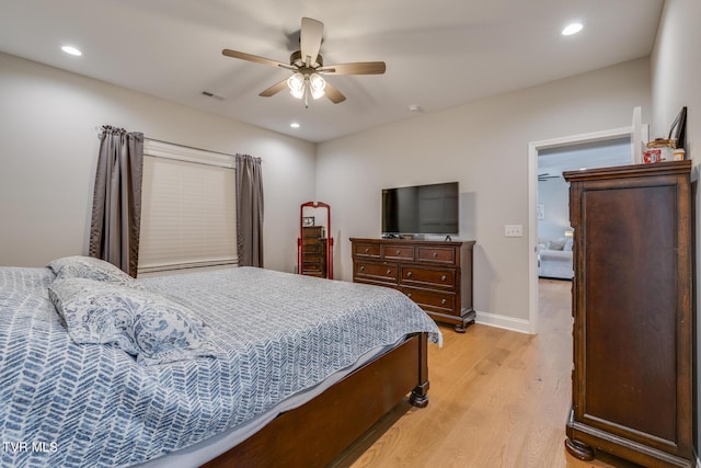 bedroom with light hardwood / wood-style flooring and ceiling fan