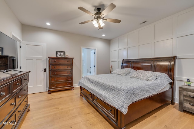 bedroom with light hardwood / wood-style floors and ceiling fan