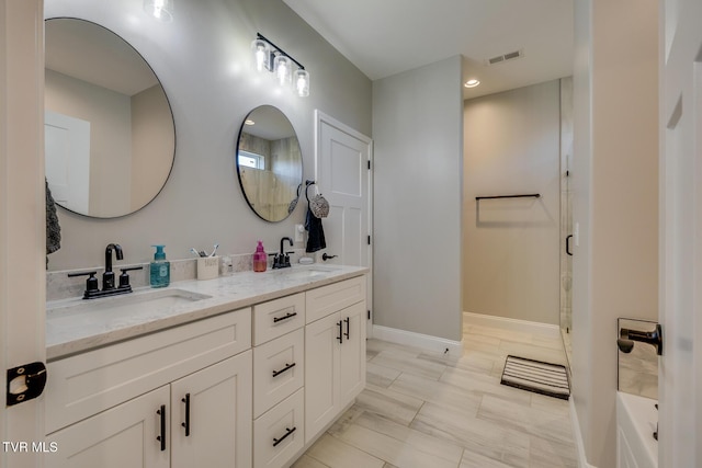 bathroom featuring vanity and a shower with shower door