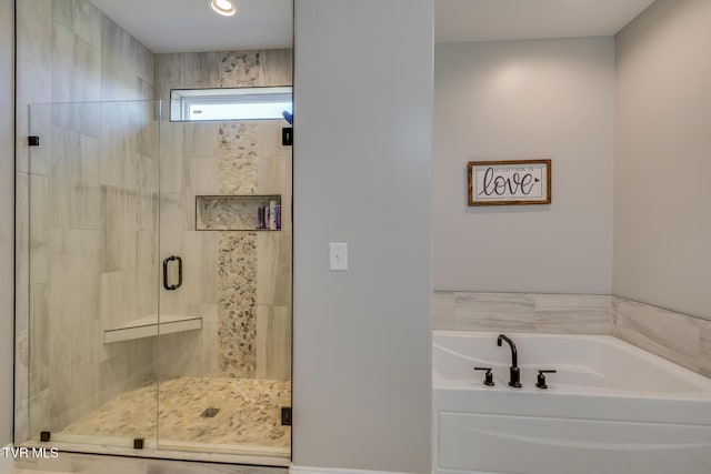 bathroom featuring separate shower and tub