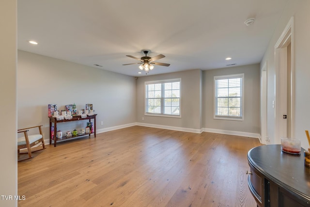 interior space with light wood-type flooring and ceiling fan