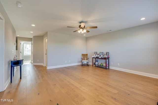 misc room with ceiling fan and light wood-type flooring