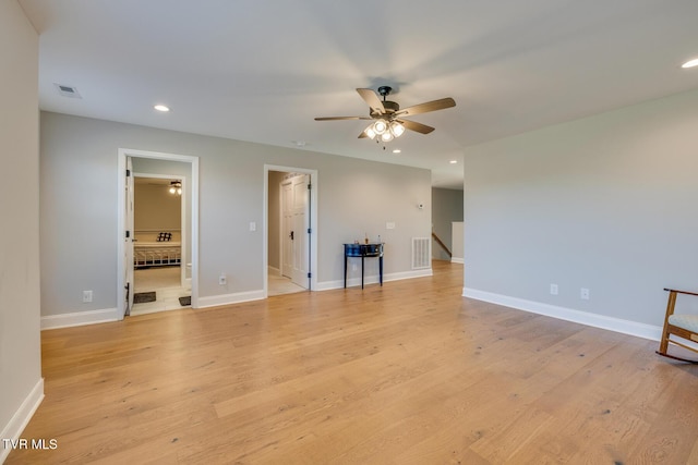 spare room featuring ceiling fan and light wood-type flooring