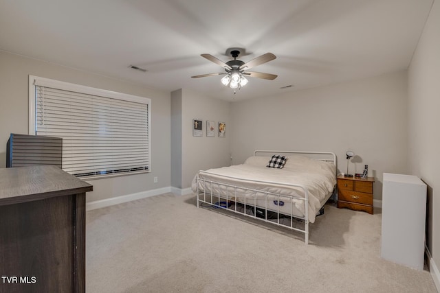 bedroom with ceiling fan and light colored carpet