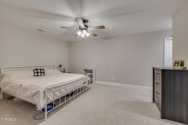 bedroom with ceiling fan and light carpet