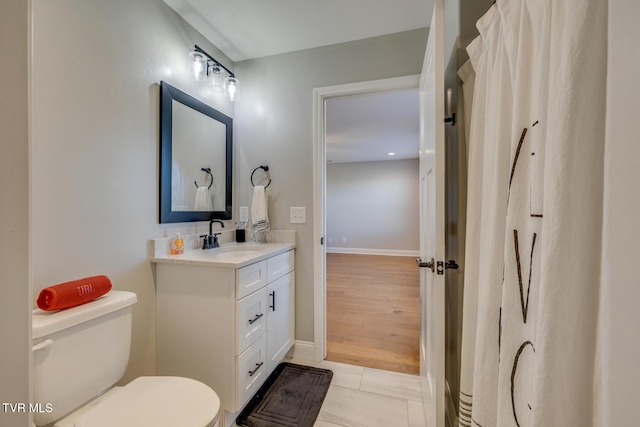 bathroom featuring tile patterned floors, vanity, and toilet