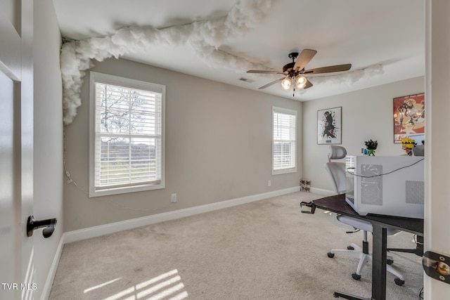 office area with ceiling fan, carpet, and a healthy amount of sunlight