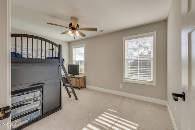 interior space featuring ceiling fan and light carpet