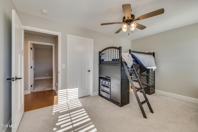 bedroom with ceiling fan and light carpet