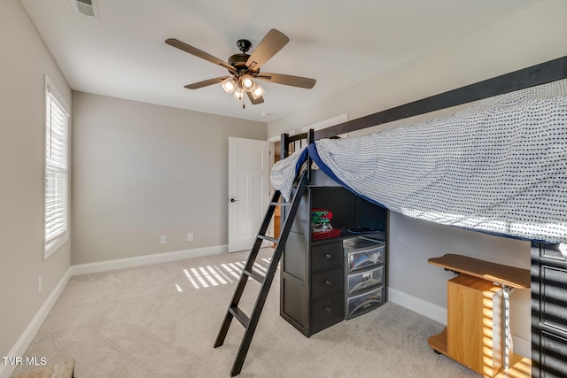 unfurnished bedroom with light colored carpet and ceiling fan