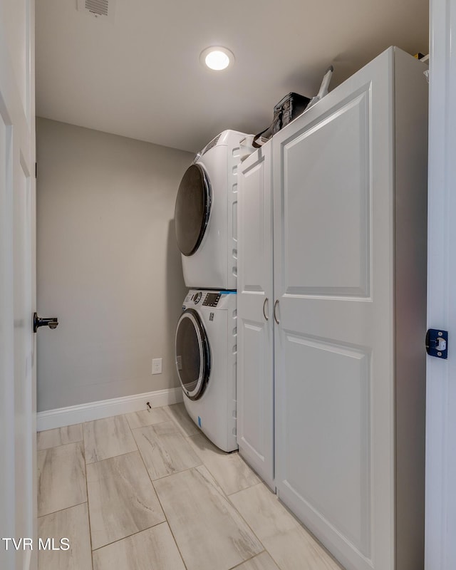 washroom with stacked washer / drying machine