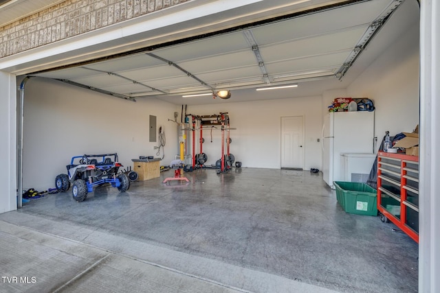 garage featuring white refrigerator and electric panel