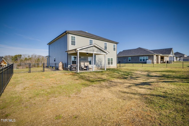 back of house with a patio, ceiling fan, and a lawn