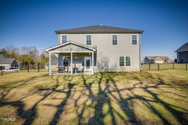 rear view of house with a patio area and a yard