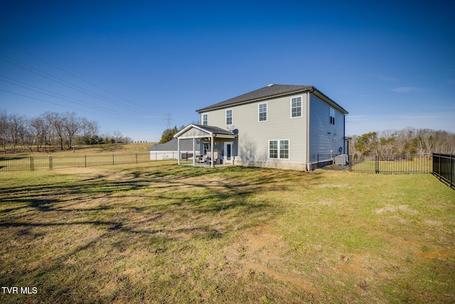 back of property with a lawn and a patio