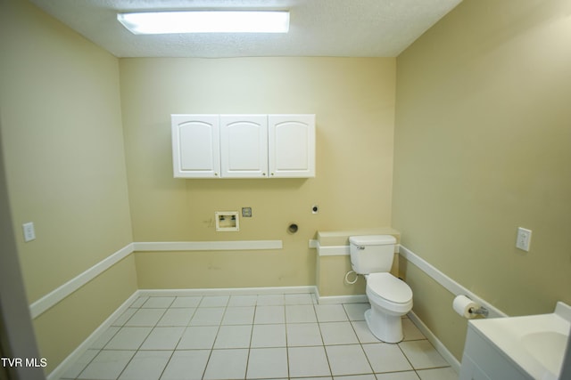 bathroom featuring tile patterned floors, a textured ceiling, and toilet