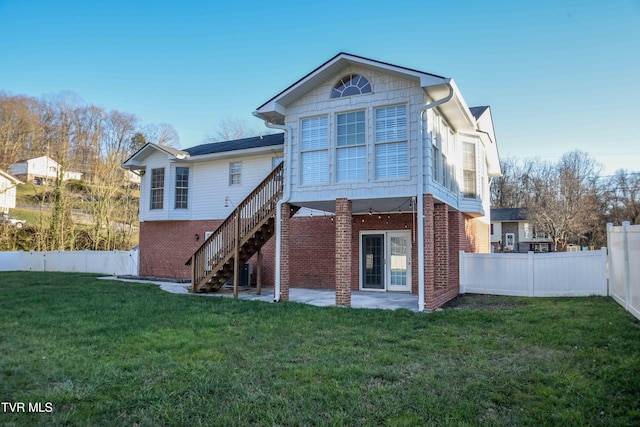 rear view of property featuring a yard