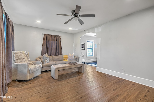 living room featuring ceiling fan and hardwood / wood-style flooring