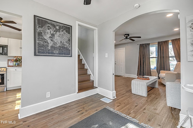 living room featuring light wood-type flooring and ceiling fan