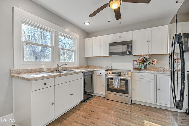 kitchen featuring white cabinets and black appliances