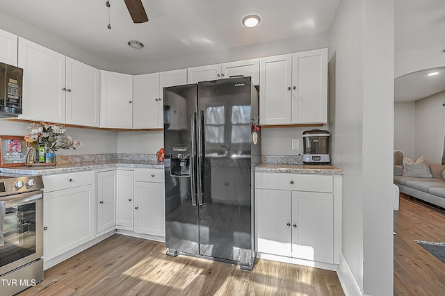 kitchen featuring white cabinets and black appliances