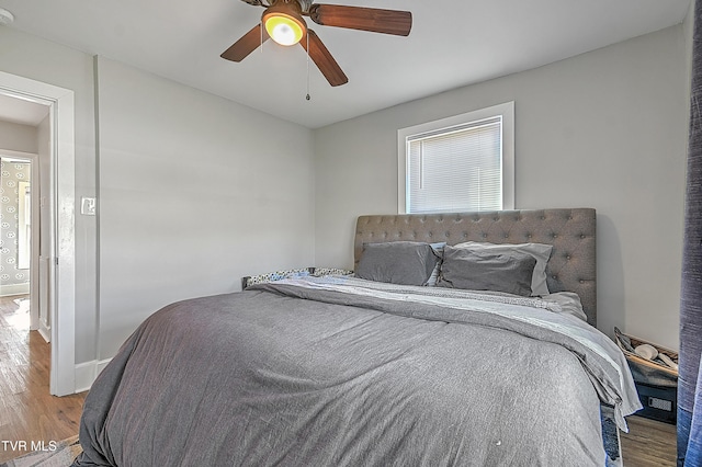 bedroom with ceiling fan and hardwood / wood-style flooring