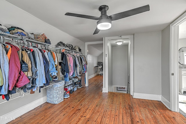 walk in closet with hardwood / wood-style floors, ceiling fan, and lofted ceiling