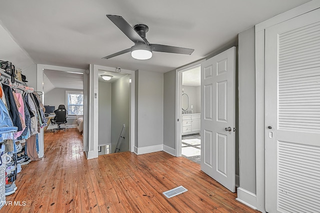 bedroom with light hardwood / wood-style floors, vaulted ceiling, and ceiling fan