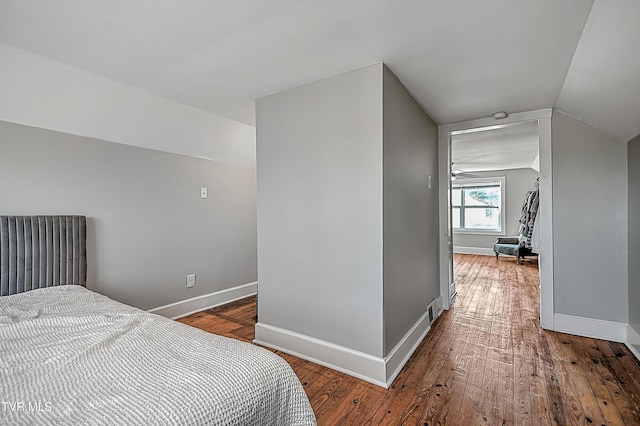 bedroom featuring hardwood / wood-style flooring and lofted ceiling