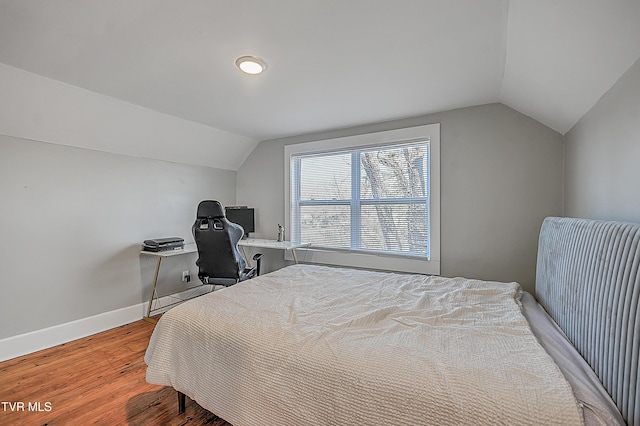 bedroom featuring wood-type flooring and vaulted ceiling