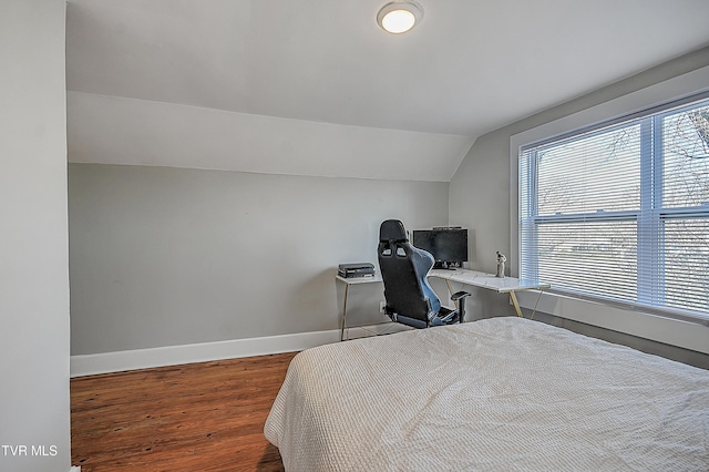 bedroom with hardwood / wood-style flooring and vaulted ceiling