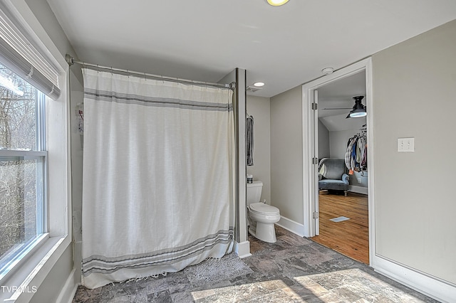 bathroom featuring hardwood / wood-style flooring, toilet, and ceiling fan