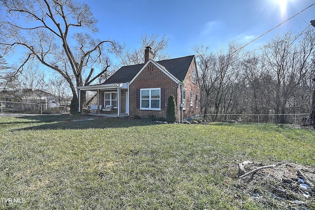 view of side of home with a lawn