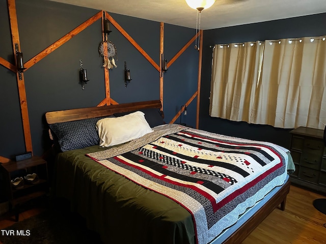 bedroom with hardwood / wood-style floors