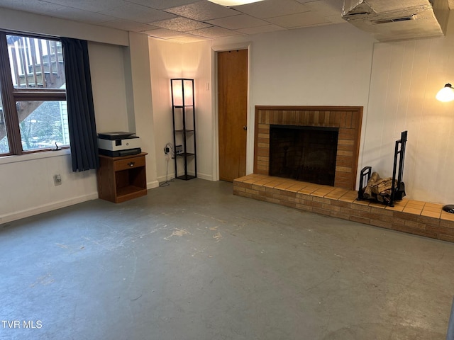 unfurnished living room with a fireplace and concrete floors