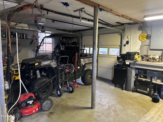 garage featuring a workshop area, electric panel, and a garage door opener