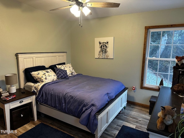 bedroom with ceiling fan and dark wood-type flooring