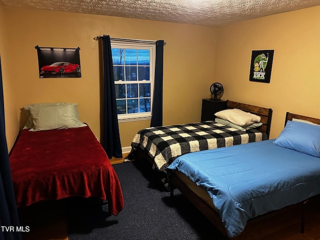 bedroom with carpet flooring and a textured ceiling