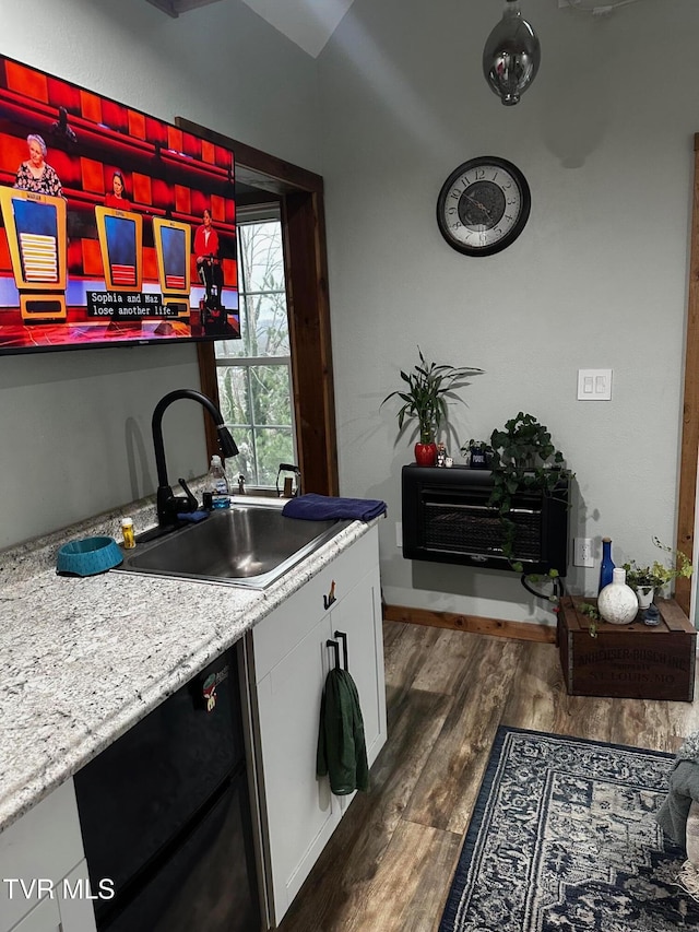 kitchen featuring light stone countertops, dishwasher, sink, dark hardwood / wood-style flooring, and white cabinets