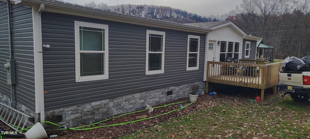 view of side of property featuring a deck