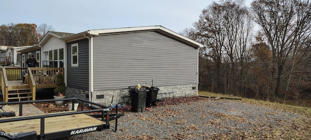 view of home's exterior featuring a wooden deck